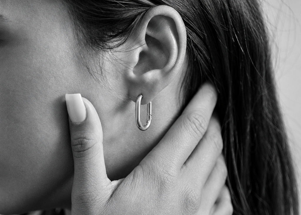 ORRÉ Oval Huggie Earrings in gold — styled jewelry photograph