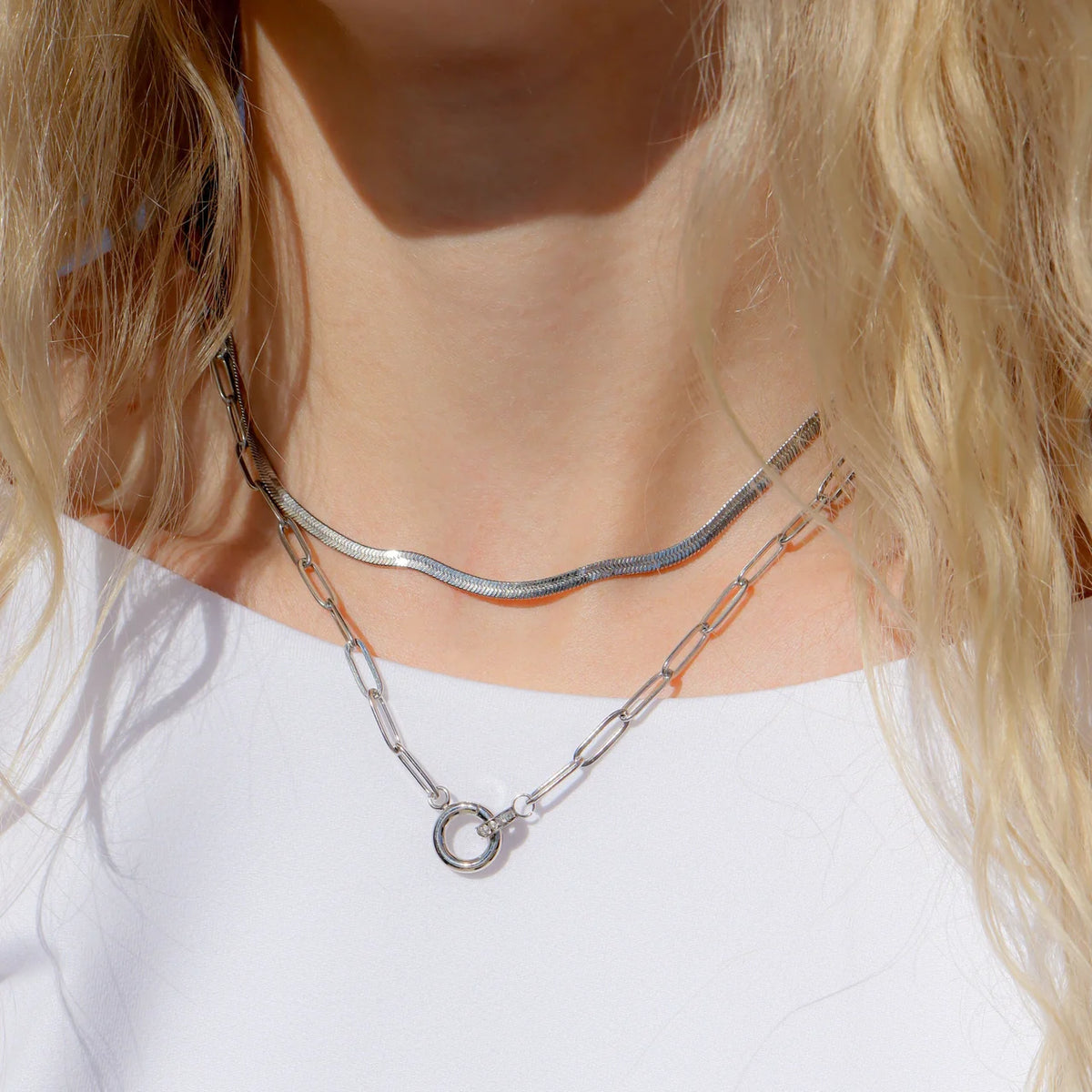 ORRÉ silver Crystal Paperclip Charmkeeper Necklace styled on a model with layered chains