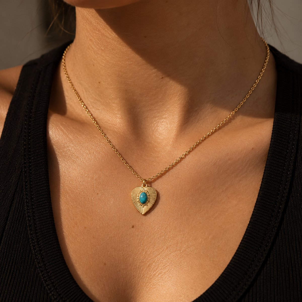 ORRÉ turquoise sunburst heart charm styled on a model